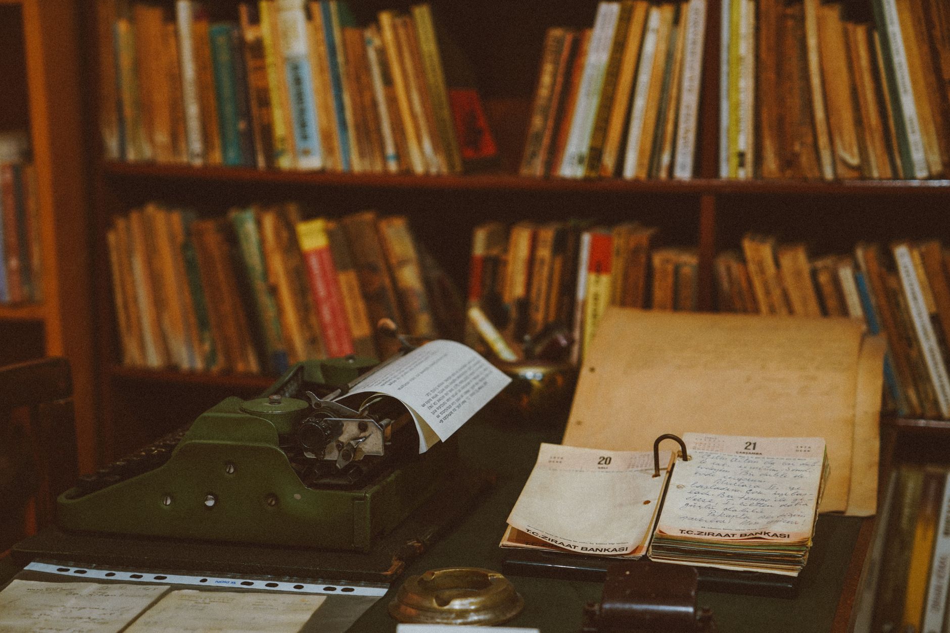 Travel writer taking notes in a library atelier